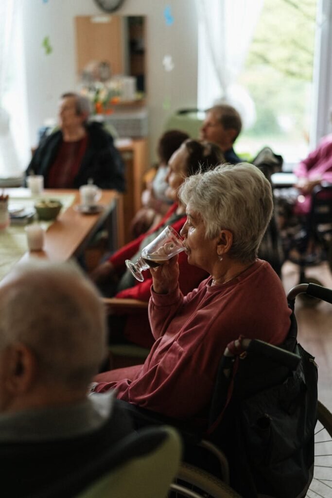 A cozy indoor gathering of elderly individuals enjoying coffee together.